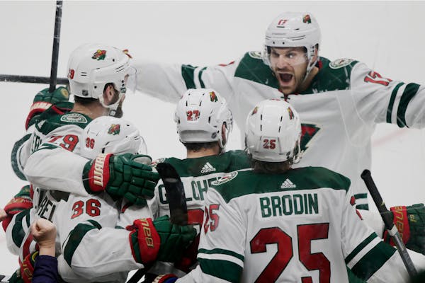 The Wild's Marcus Foligno, above right, celebrates with Greg Pateryn, left, Mats Zuccarello, second from left and Jonas Brodin after a goal on March 8
