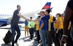 Golden State Warriors forward David Lee greets team employees after the team landed in Oakland, Calif., Wednesday, June 17, 2015. The Warriors beat th