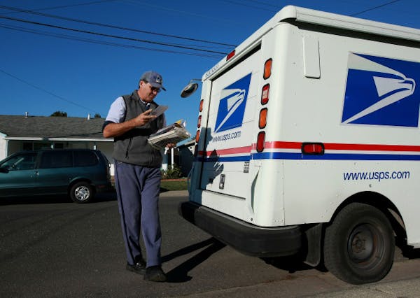 U.S. Postal Service letter carrier Dennis Stecz delivers mail in San Lorenzo, Calif.