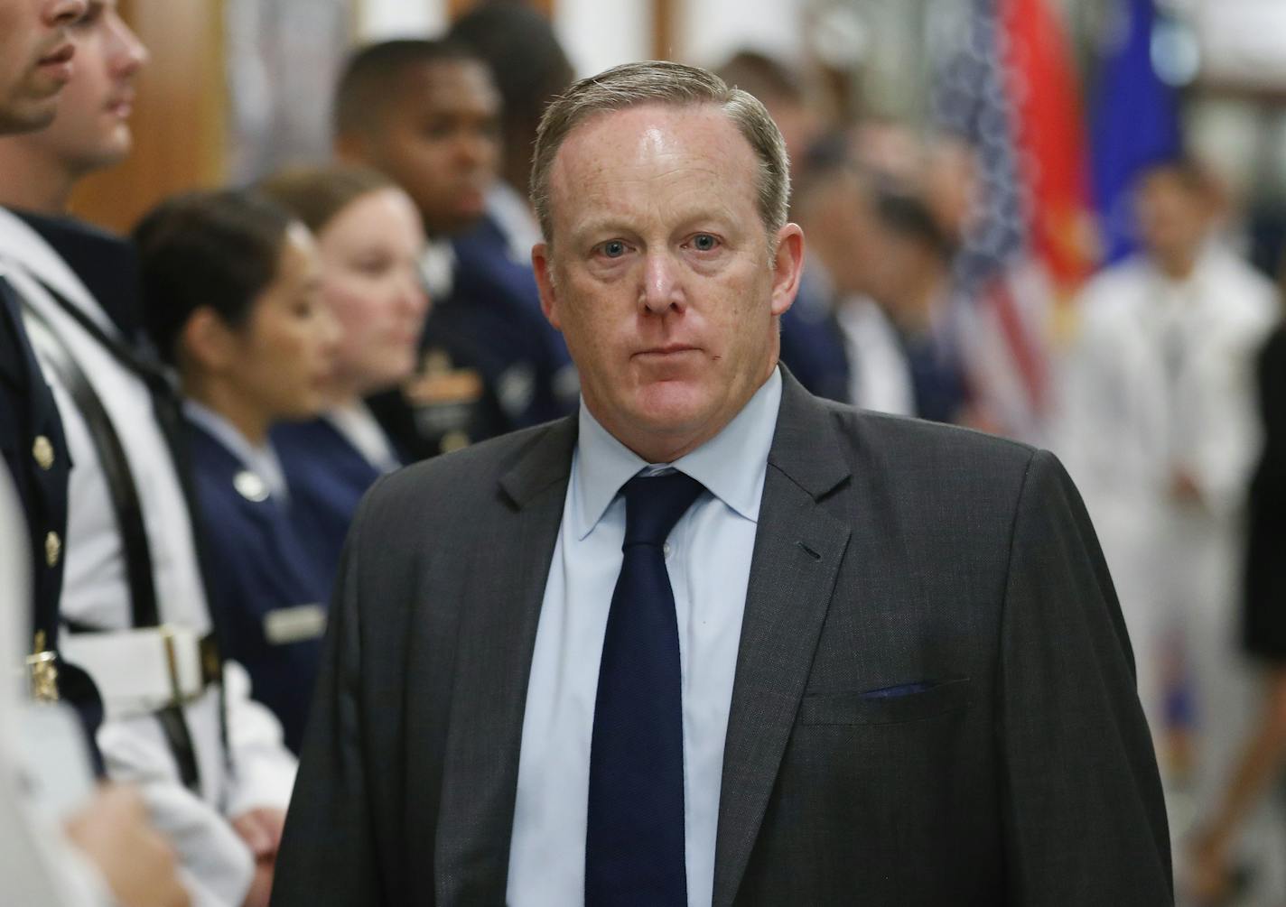 White House press secretary Sean Spicer walks down the hallway during President Donald Trump's visit to the Pentagon on Thursday.