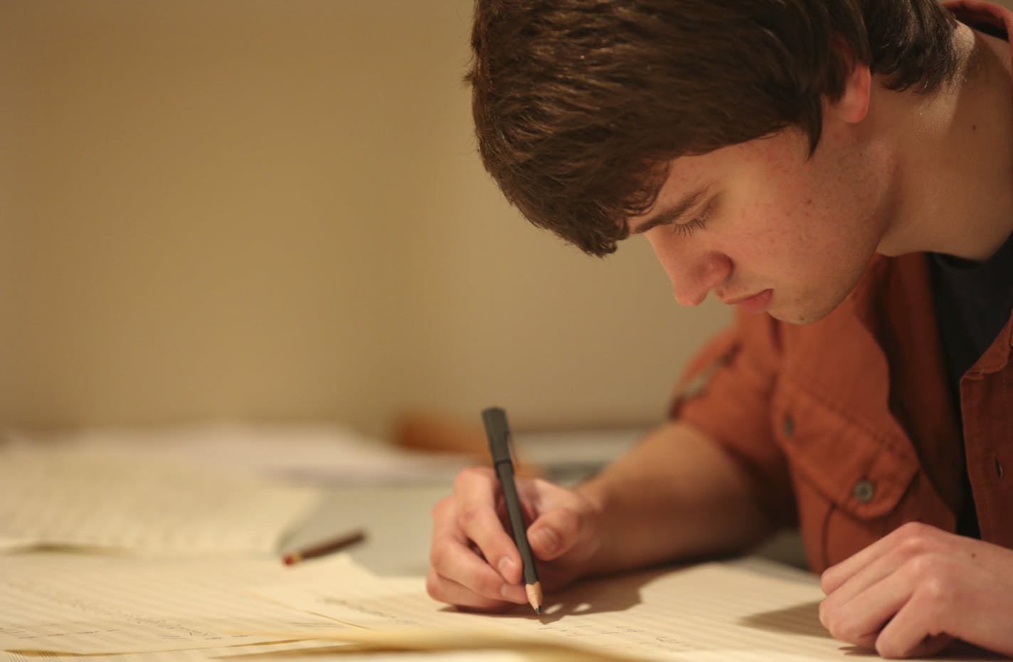 Grant Luhmann, 18, wrote out a of piece of music in his work area in the basement of his home in Lino Lakes Min., Friday, May 24, 2013. Luhmann was one of six young composers to be honored by the American Society of Composers Authors and Publishers. ] (KYNDELL HARKNESS/STAR TRIBUNE) kyndell.harkness@startribune.com