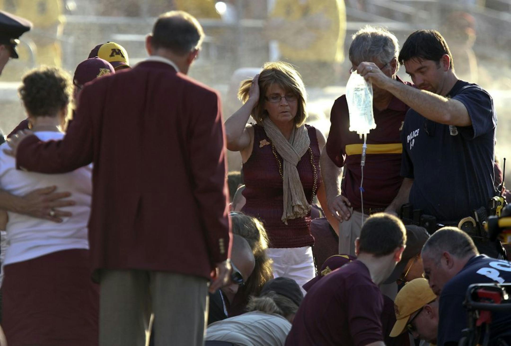 Gopher Rebbecca Kill watched as medics worked on her husband head coach Jerry Kill after he had a seizure near the end of the game at TCF Bank Stadium in Minneapolis, Minn., Saturday, September 10, 2011. New Mexico State won 28-21.