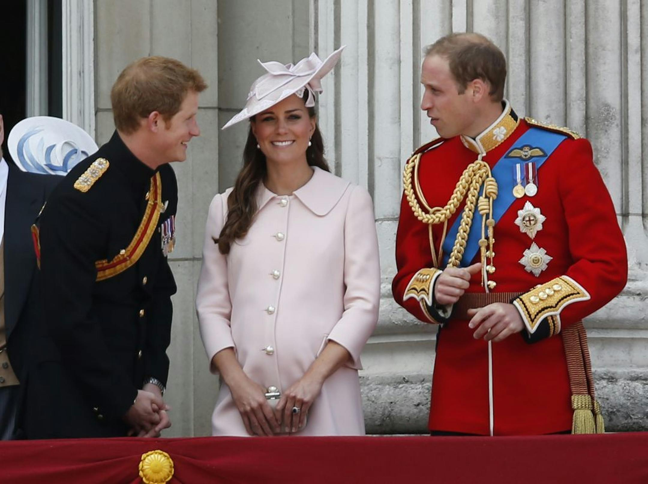 Britain's Prince Harry, left, Kate, Duchess of Cambridge, center, and Prince William, on the balcony of Buckingham Palace, during the Trooping The Colour parade, in London, Saturday, June 15, 2013. Queen Elizabeth II celebrated her birthday with traditional pomp and circumstance _ but without her husband by her side. Prince Philip remains in the hospital, recovering from exploratory abdominal surgery. The queen invited her cousin, the Duke of Kent, to accompany her in a vintage carriage. Other r
