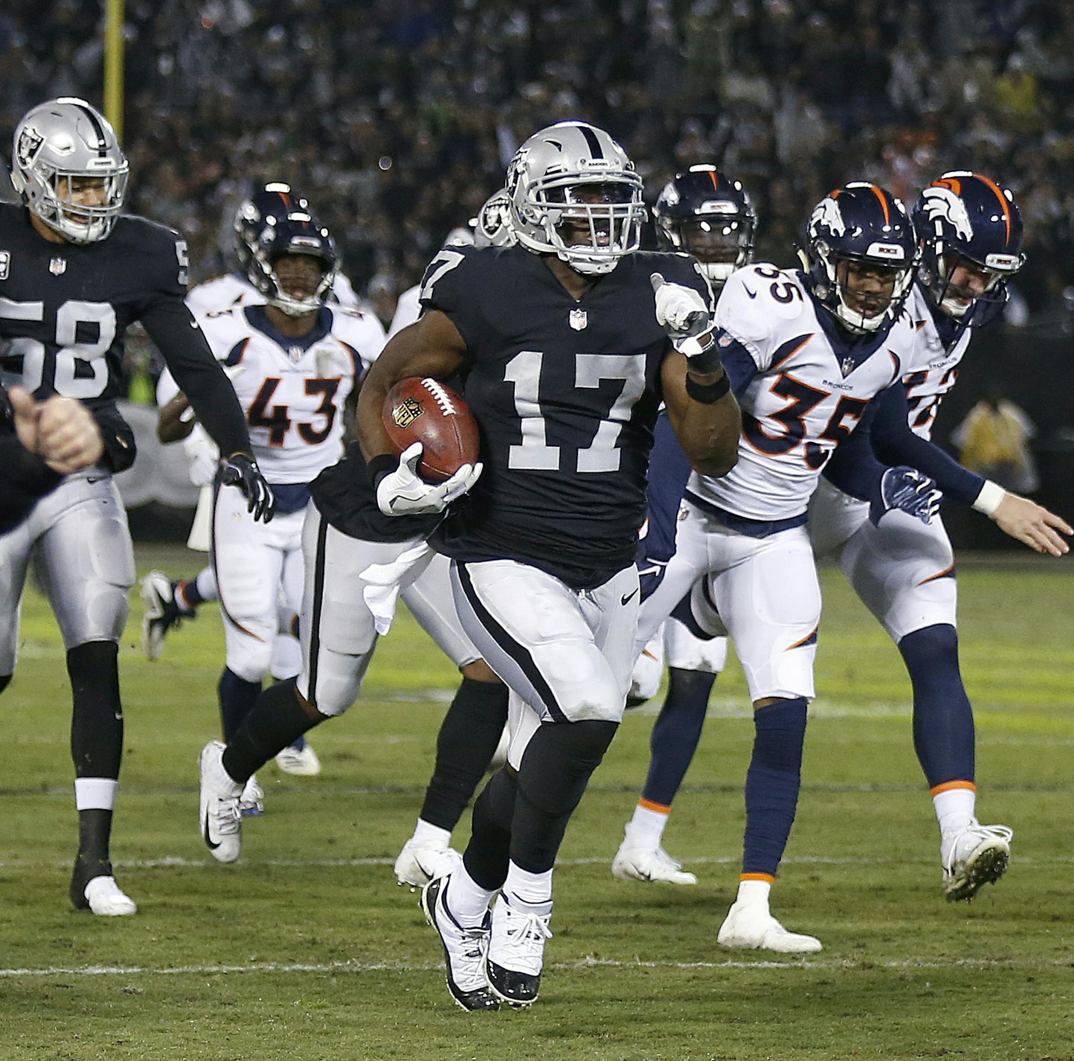 Oakland Raiders' Dwayne Harris (17) returns a punt for a touchdown against the Denver Broncos during the first half of an NFL football game in Oakland, Calif., Monday, Dec. 24, 2018. (AP Photo/D. Ross Cameron)