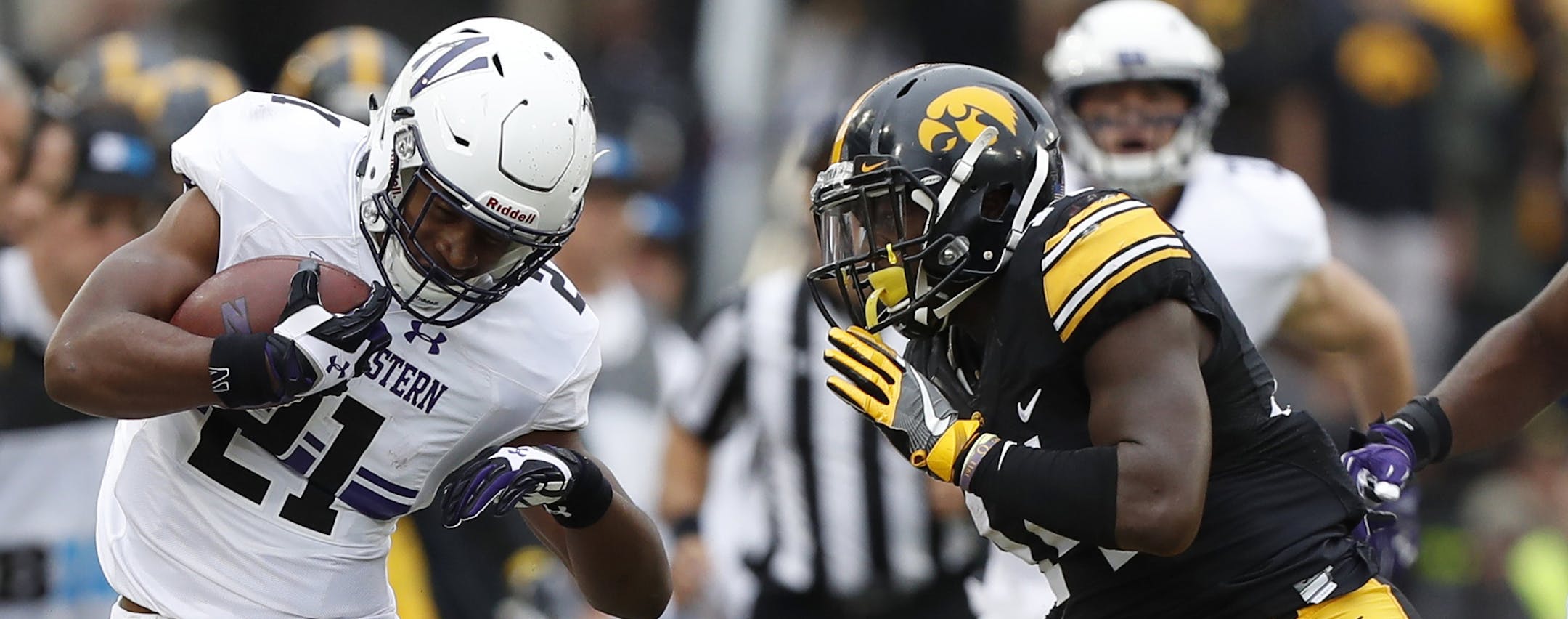 Northwestern running back Justin Jackson (21) runs from from Iowa defensive back Desmond King, right, during the first half of an NCAA college football game, Saturday, Oct. 1, 2016, in Iowa City, Iowa. (AP Photo/Charlie Neibergall) ORG XMIT: IACN1