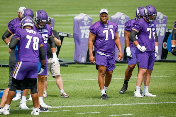 Minnesota Vikings linemen Christian Darrisaw (71) watches drills during NFL training camp Wednesday, July 28, 2021, in Eagan, Minn. (AP Photo/Bruce Kl