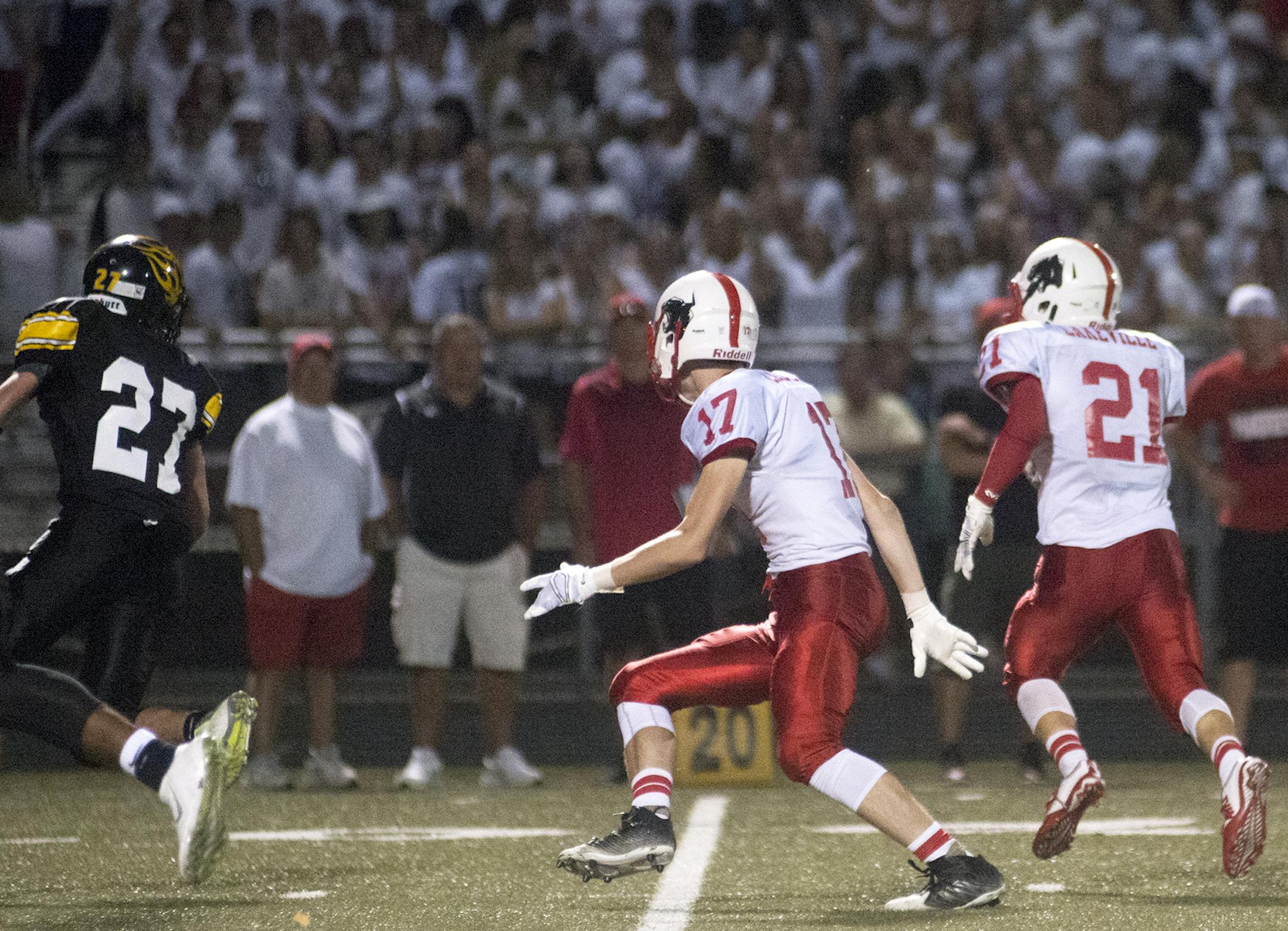 Lakeville North's David Lindstrand blocks for running back Wade Sullivan as he takes off on the 37 yard touchdown late in the fourth quarter, Friday, Sept. 4, that put Lakeville North up over Burnsville 29-18. ] (Matthew Hintz, 090415, Burnsville)