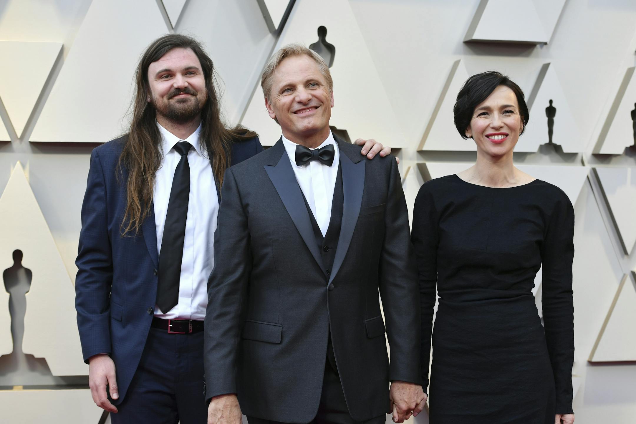 Henry Mortensen, from left, Viggo Mortensen, and Ariadna Gil arrive at the Oscars on Sunday, Feb. 24, 2019, at the Dolby Theatre in Los Angeles.