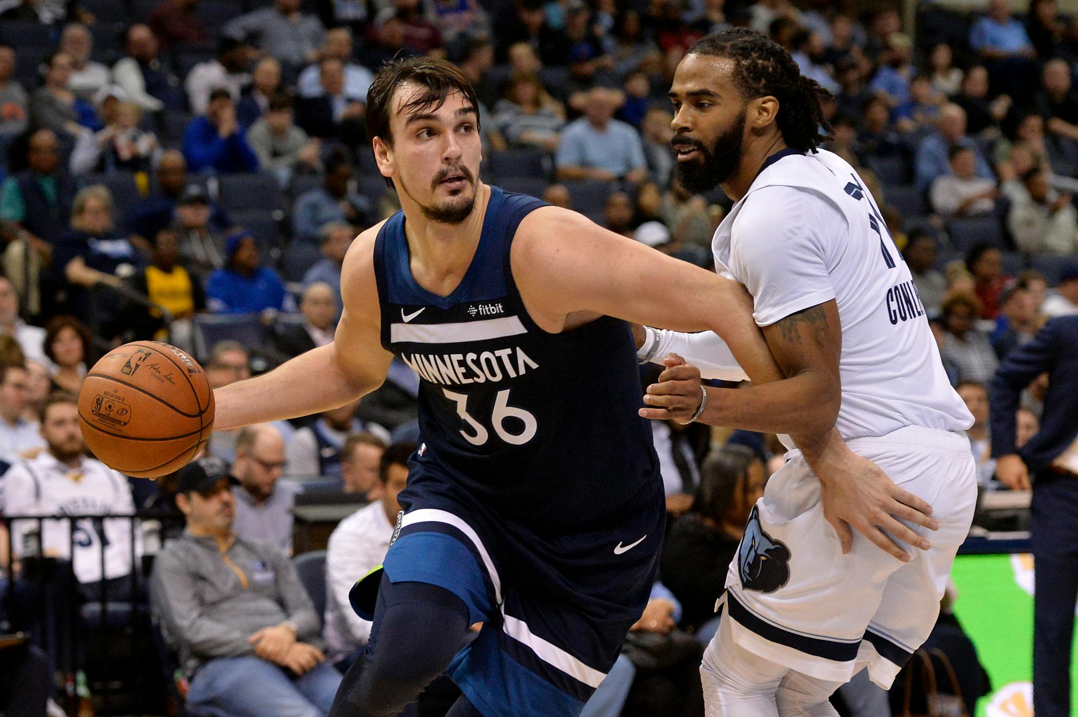 Timberwolves forward Dario Saric, left, drives against Memphis guard Mike Conley