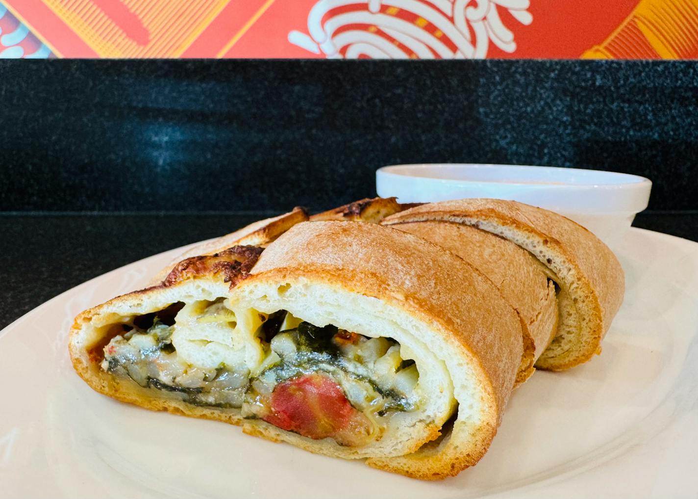 The vegetarian stromboli, a rolled pizza dough stuffed with spinach, crushed tomato, potato, artichoke, gorgonzola, mozzarella at Broders' Cucina Italiana.