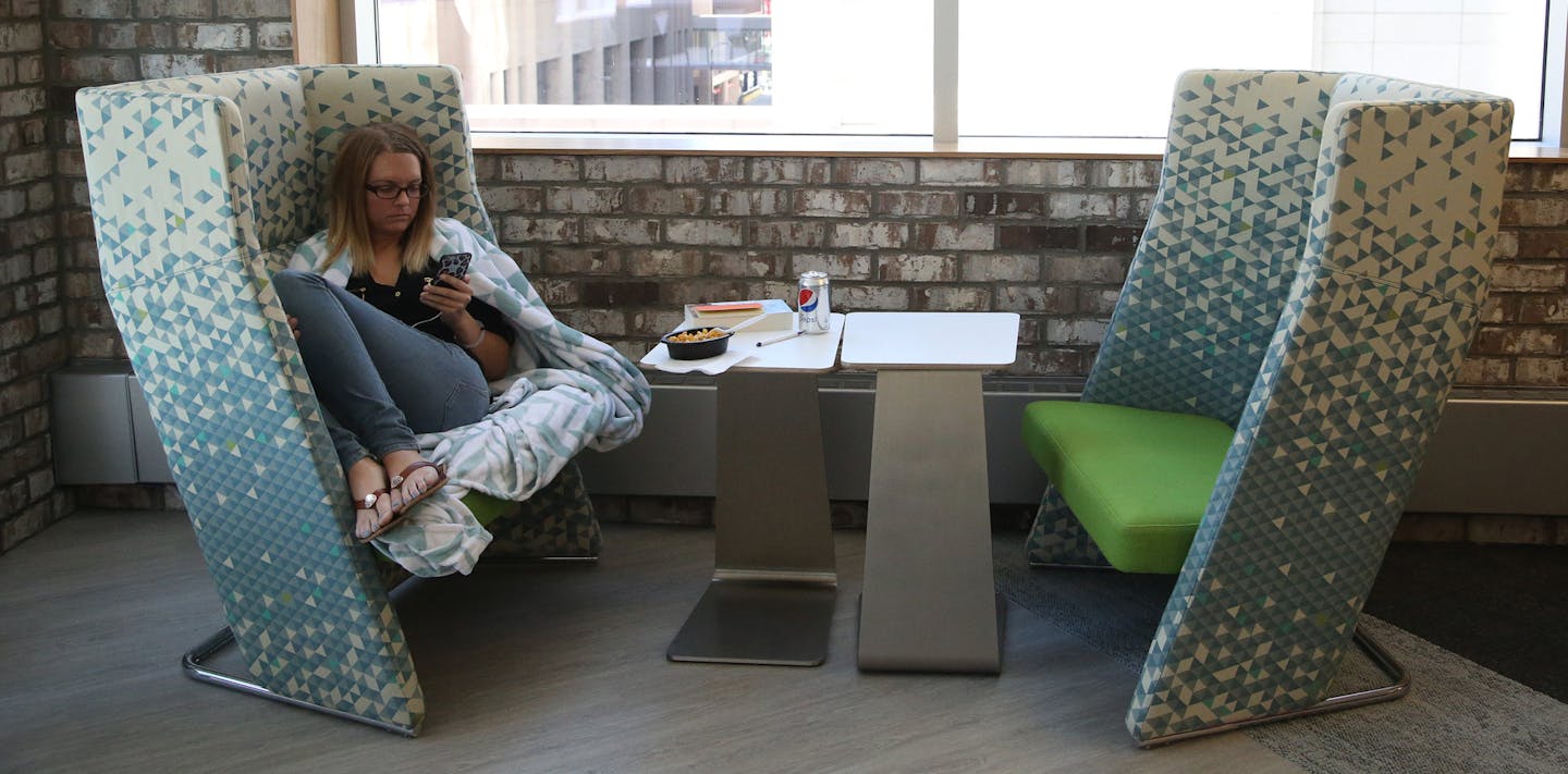 Kelly Porter, library assistant, got cozy while taking her lunch break in one of the eating areas on the newly redesigned fourth floor. ] (KYNDELL HARKNESS/STAR TRIBUNE) kyndell.harkness@startribune.com Fish & Richardson is a law firm that has recently built out a "hub" space -- or entire floor -- for its administrative departments in Minneapolis, Min., Friday July 31, 2015. t&#xed;s an intellectual property law firm and so they are careful about proprietary information. The photog will be asked