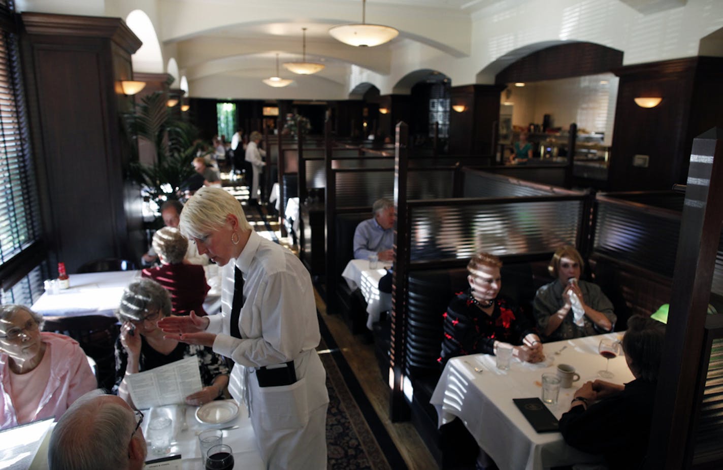 Richard Tsong-Taatarii/rtsong-taatarii@startribune.com St. Paul, MN;5/26/10;left to right ] At the St. Paul Grill, waitress Desiree King enjoys the interaction with clients.