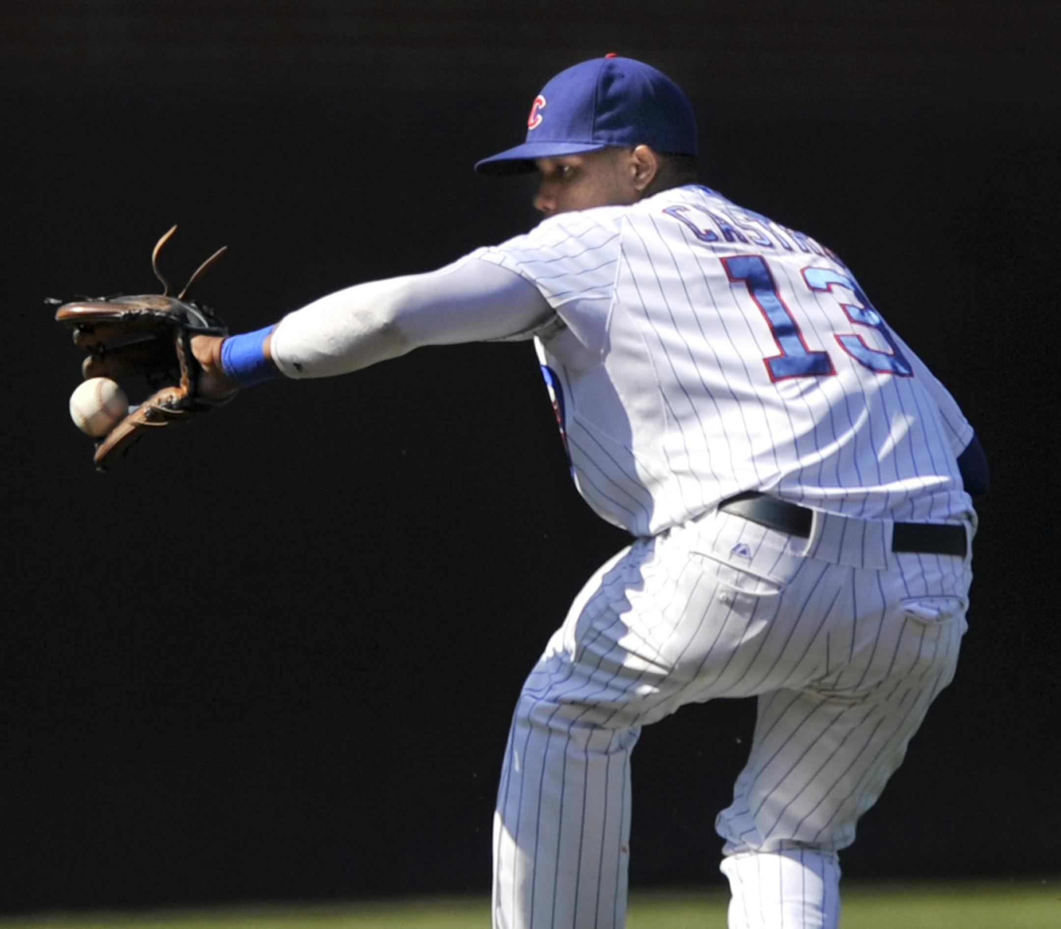 Chicago Cubs shortstop Starlin Castro stops a grounder hit by St. Louis Cardinals' Pete Kozma during the fourth inning of a baseball game in Chicago, Saturday, Aug. 17, 2013. St. Louis won 4-0. (AP Photo/Paul Beaty)