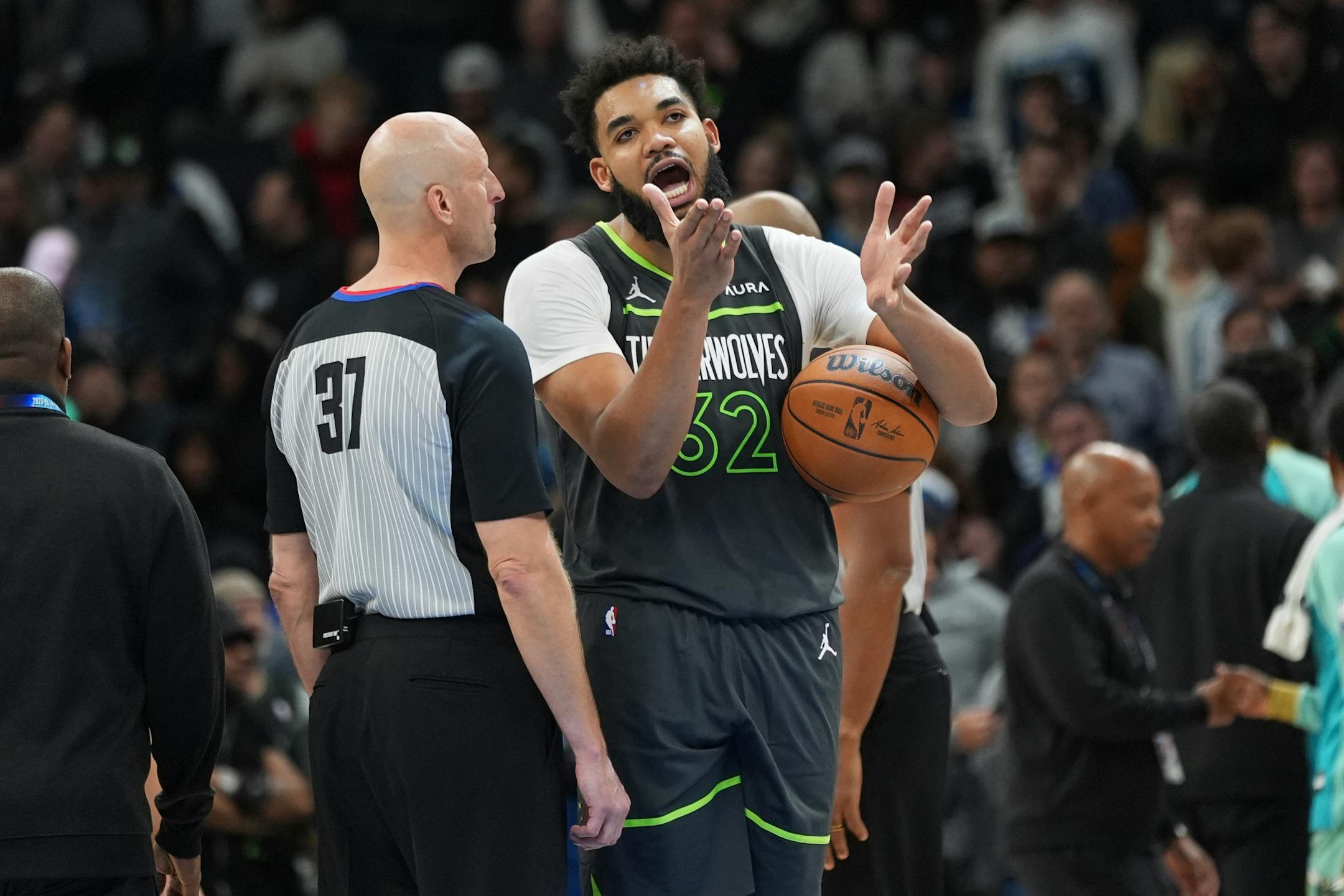 Karl-Anthony Towns (32) talks with referee Eric Dalen after not receiving a foul call off a shot during the final seconds of Monday's game.