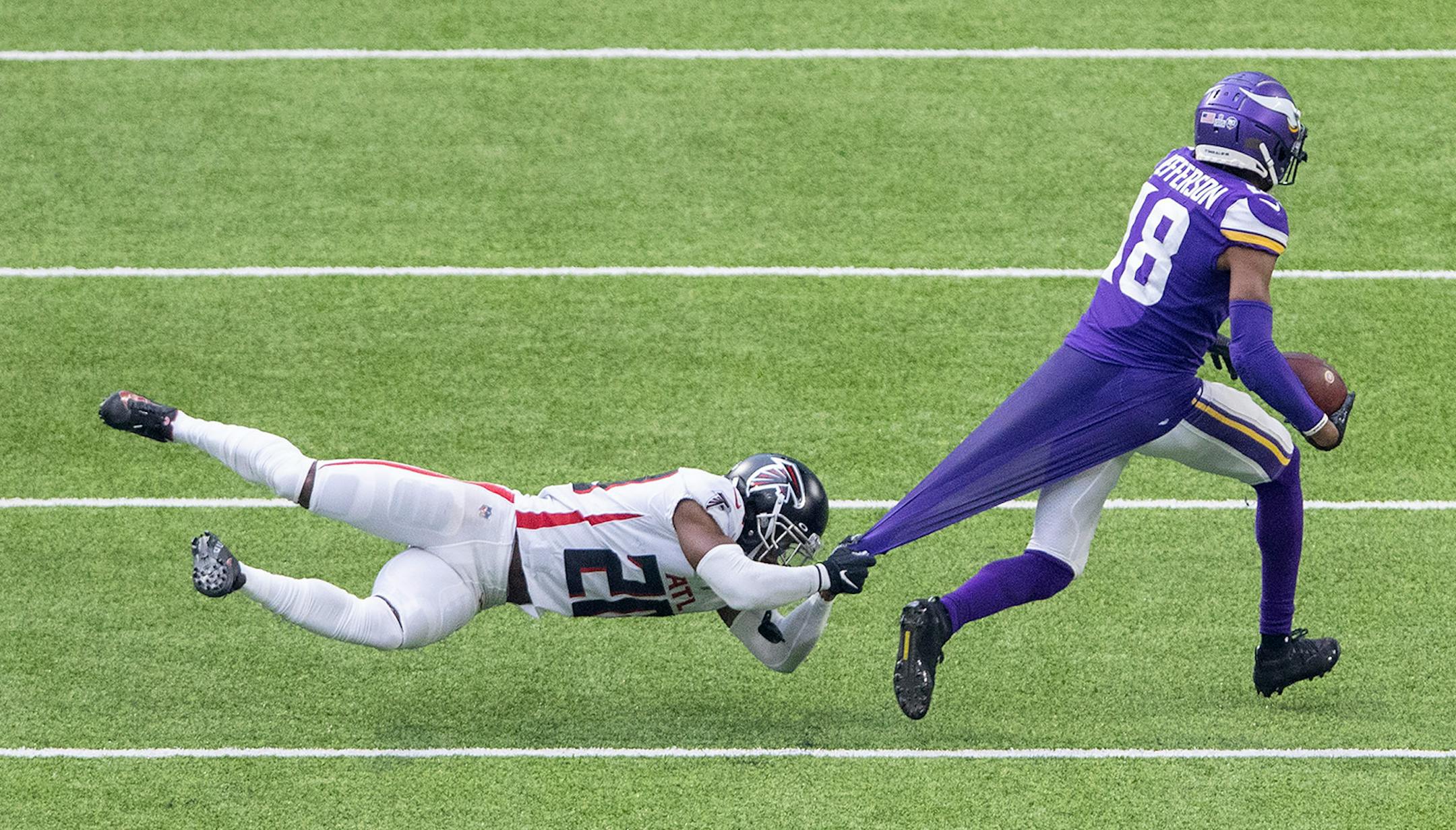 Minnesota Vikings receiver Justin Jefferson (18) broke away from Kendall Sheffield (20) of the Atlanta Falcons during a 49-yard catch and run touchdown in the fourth quarter.
