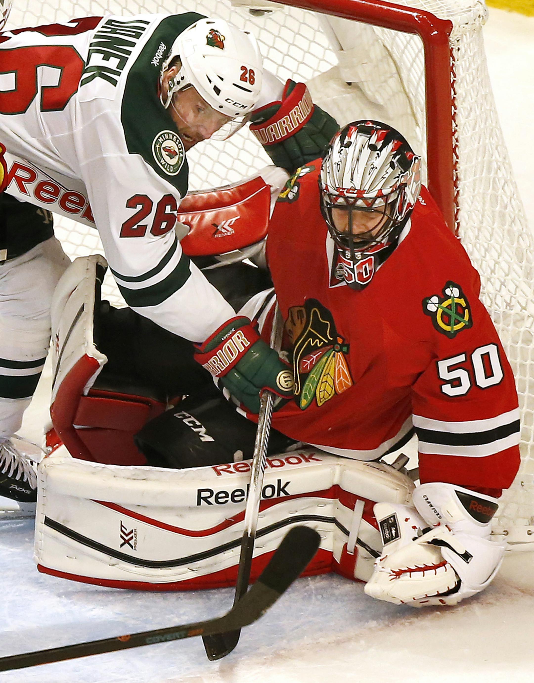 Thomas Vanek (26) got tangled up with Blackhawks goalie Corey Crawford (50) in the first period. Vanek was called for interference on the play. ] CARLOS GONZALEZ cgonzalez@startribune.com, May 3, 2015, Chicago, IL, United Center, NHL, Minnesota Wild vs. Chicago Blackhawks, Game 2, Stanley Cup Playoffs, Round 2