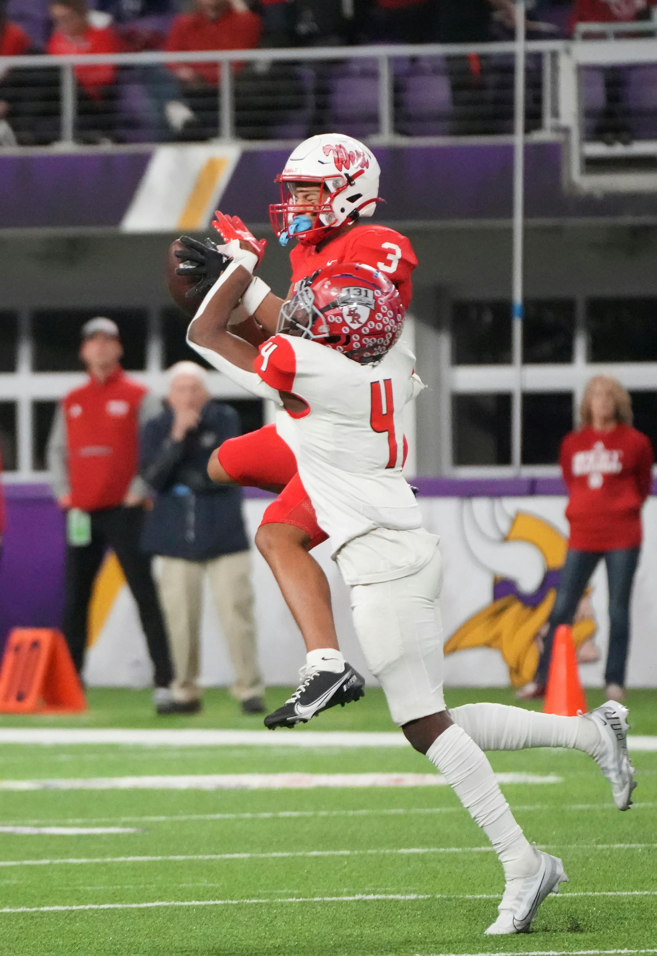 Mankato West's Jalen Smith (3) makes a catch while defended by Elk River's Darioh Balisidya (4) in the first half of the Minnesota High School football Class 5A State Championship at U.S. Bank Stadium in Minneapolis, Minn., on Saturday, Dec. 3, 2022.