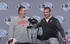 Wisconsin head coach Paul Chryst, left, talks with Ohio State head coach Urban Meyer during a news conference for the Big Ten Conference championship 