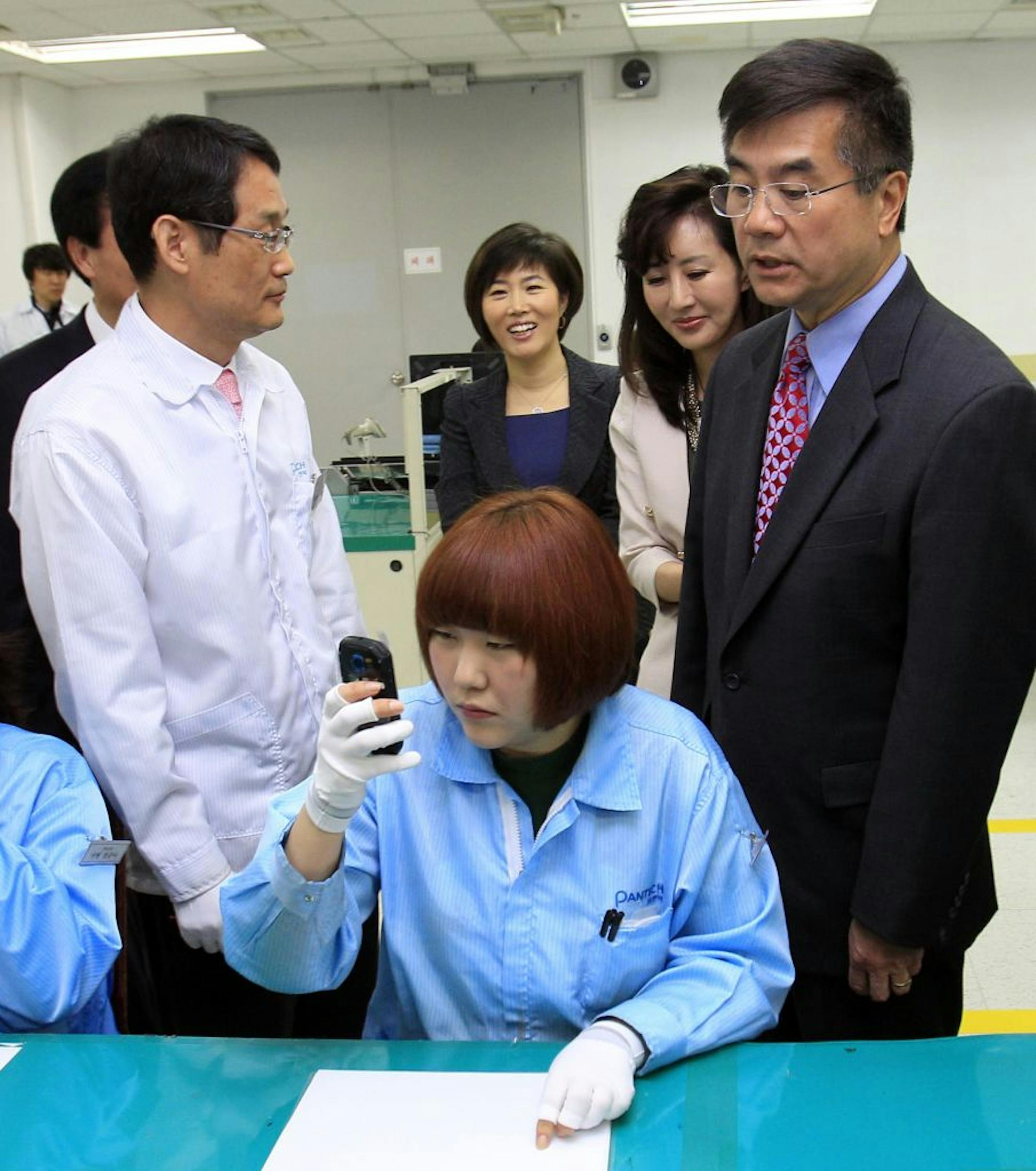 Commerce Secretary Gary Locke, right, toured a handset assembly line last month at Pantech near Seoul, South Korea. He arrived here Wednesday to build support for ratifying the pending free trade deal with South Korea.