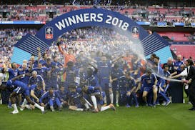 Chelsea coach Antonio Conte, right, sprayed the players with champagne after winning the English FA Cup final soccer match between Chelsea and Manches