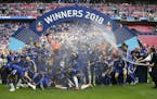 Chelsea coach Antonio Conte, right, sprayed the players with champagne after winning the English FA Cup final soccer match between Chelsea and Manches