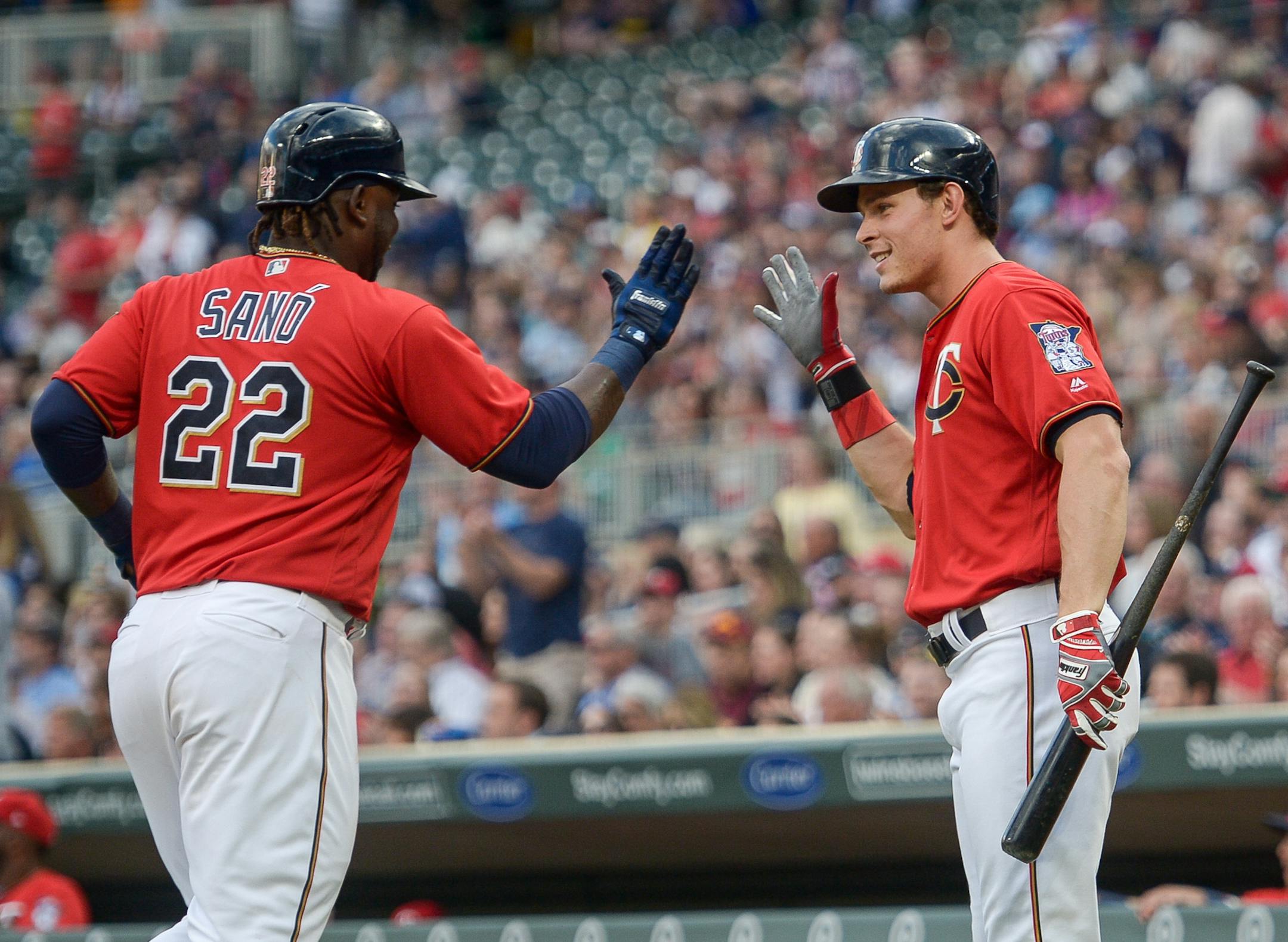 Minnesota Twins third baseman Miguel Sano (22) and center fielder Max Kepler (26) high fived after Sano scored