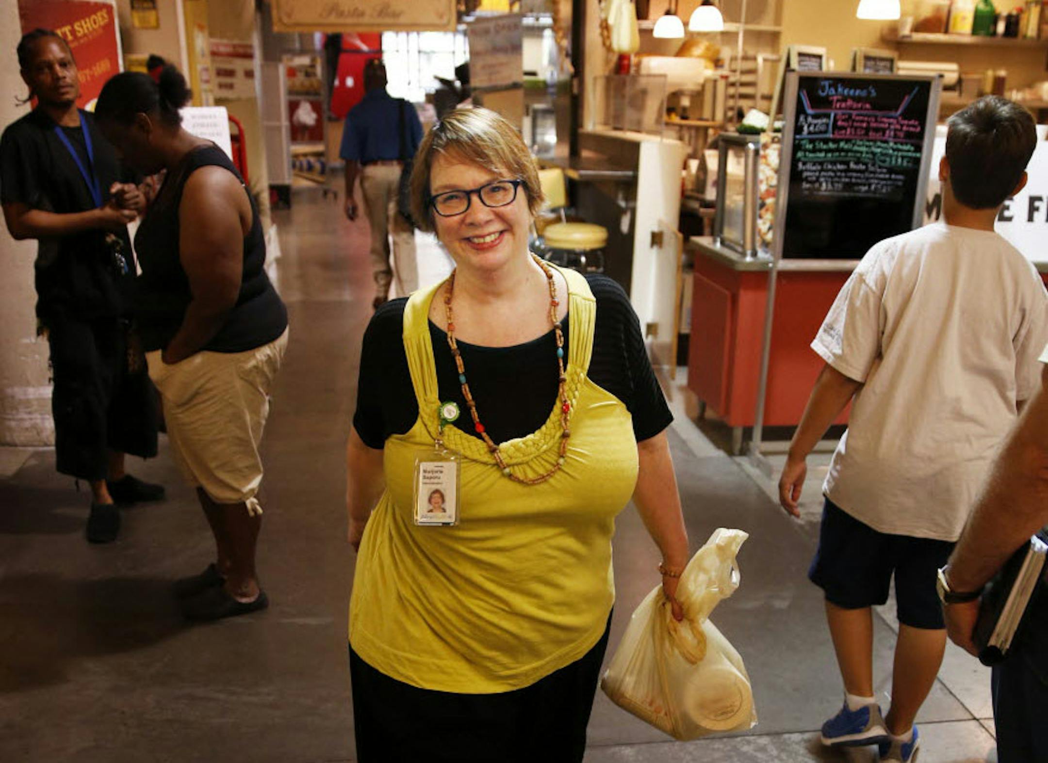 Marjorie Saporu, an administrative assistant for Allina Health, has added simple fitness routines to her day at work to deal with her weight and osteoarthritis.