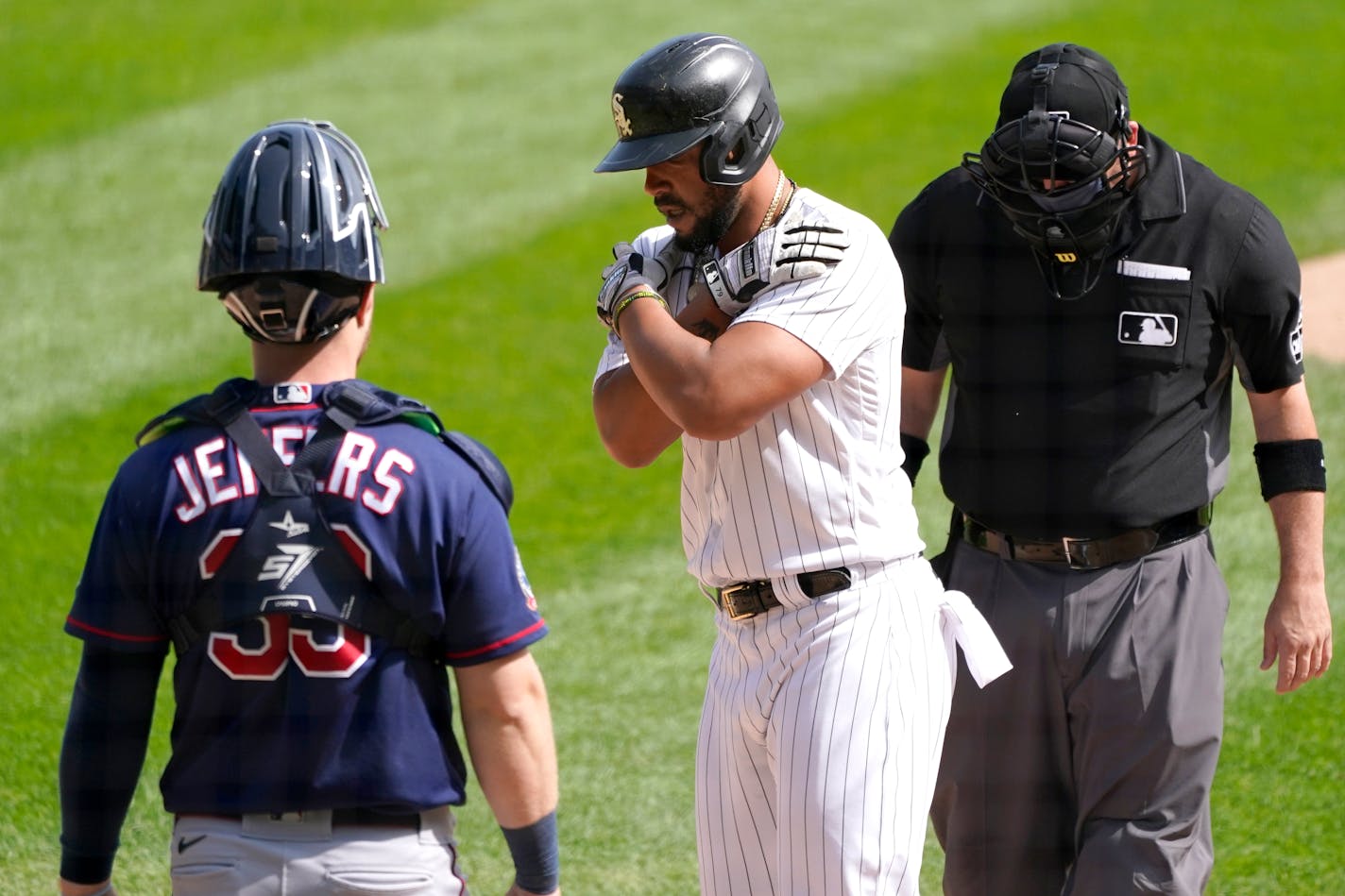 Chicago White Sox's Jose Abreu celebrates at home plate after his home run off Minnesota Twins starting pitcher Kenta Maeda as catcher Ryan Jeffers (39) and umpire Dan Bellino watch during the fourth inning of a baseball game Thursday, Sept. 17, 2020, in Chicago. (AP Photo/Charles Rex Arbogast)