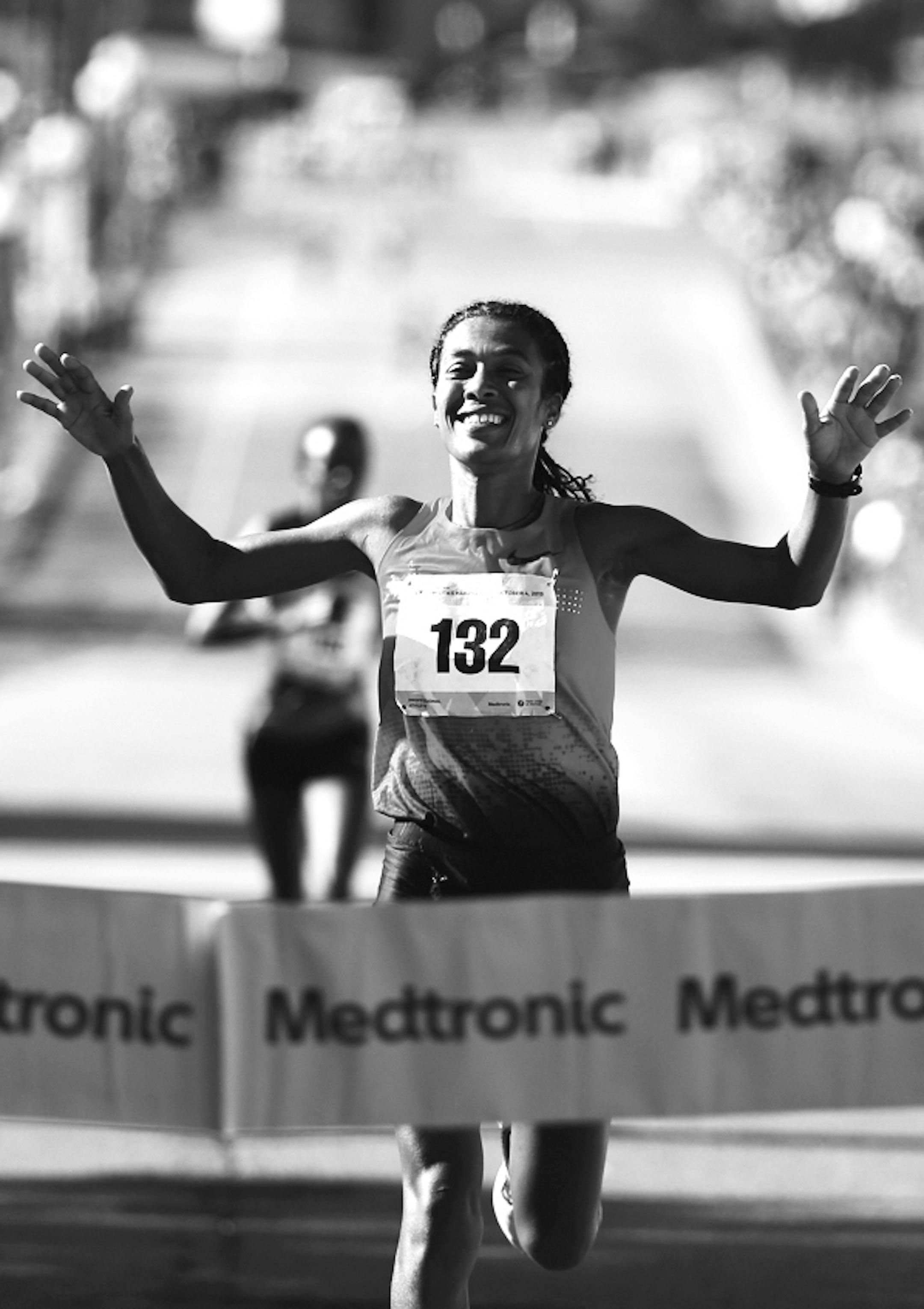 Serkalem Abraha of Ethiopia, the women's winner, crosses the finish line of the Twin Cities Marathon in St. Paul, Minn., on Sunday, Oct. 3, 2015. (Jeff Wheeler/Star Tribune via AP)