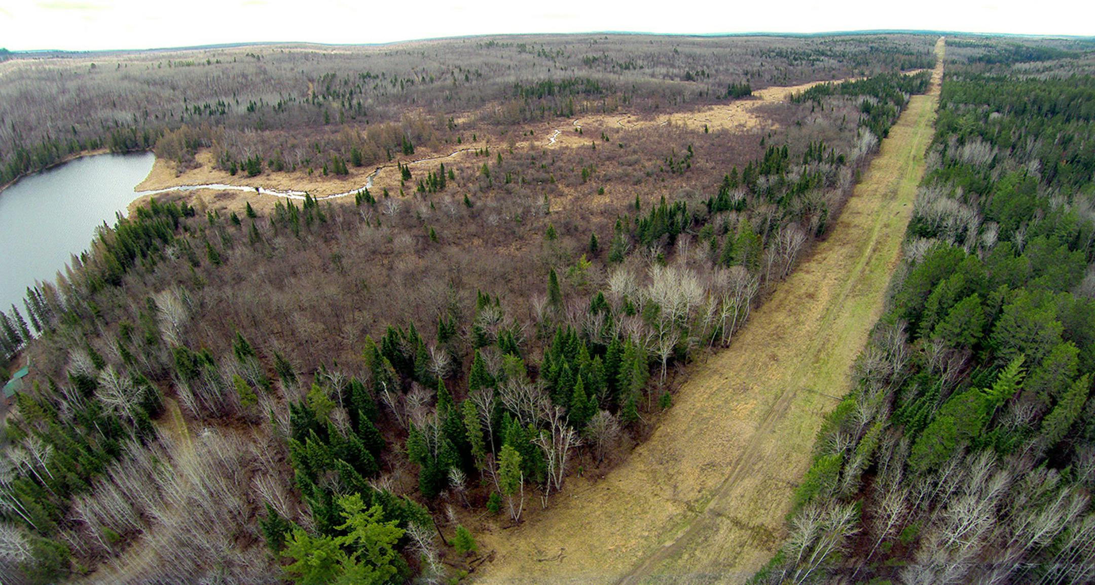 As Enbridge Energy plans another crude oil pipeline through northern Minnesota bog lands, state environmental officials are worried about the risk of another spill in sensitive natural areas, including some that are inaccessible by road. This aerial shot shows LaSalle Creek flowing into LaSalle Lake top left and the oil pipeline right of way bottom right, crossing each other at the top right.