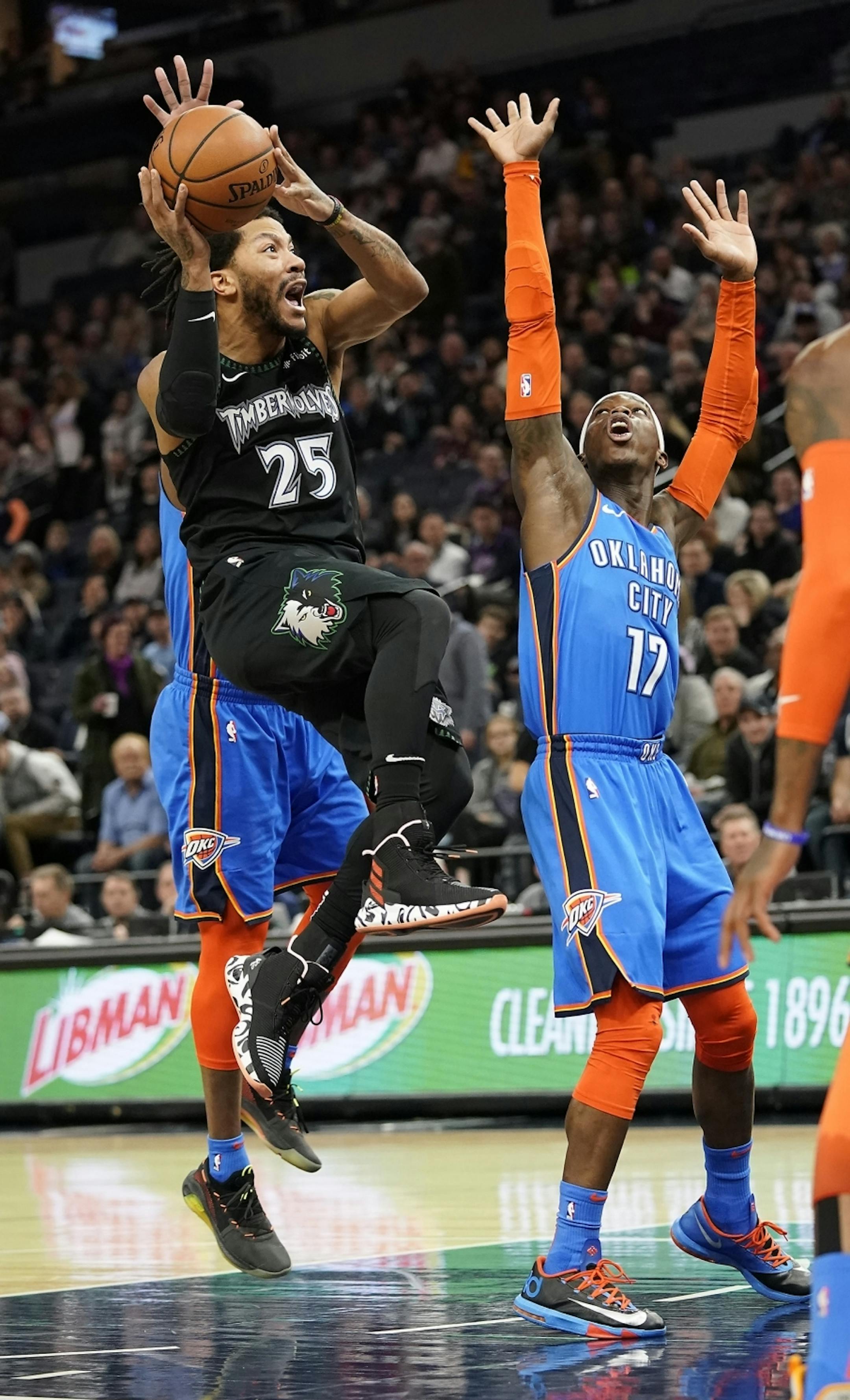 Minnesota Timberwolves guard Derrick Rose (25) shoots as Oklahoma City Thunder guard Dennis Schroder (17) defends during the first half.