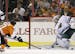 Philadelphia Flyers' Wayne Simmonds, left, scores a goal past Minnesota Wild's Niklas Backstrom, of Finland, during the first period of an NHL hockey 