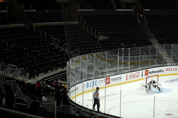 Wild goalie Cam Talbot makes a save during the third period of the team's game against the Los Angeles Kings in an empty Staples Center.