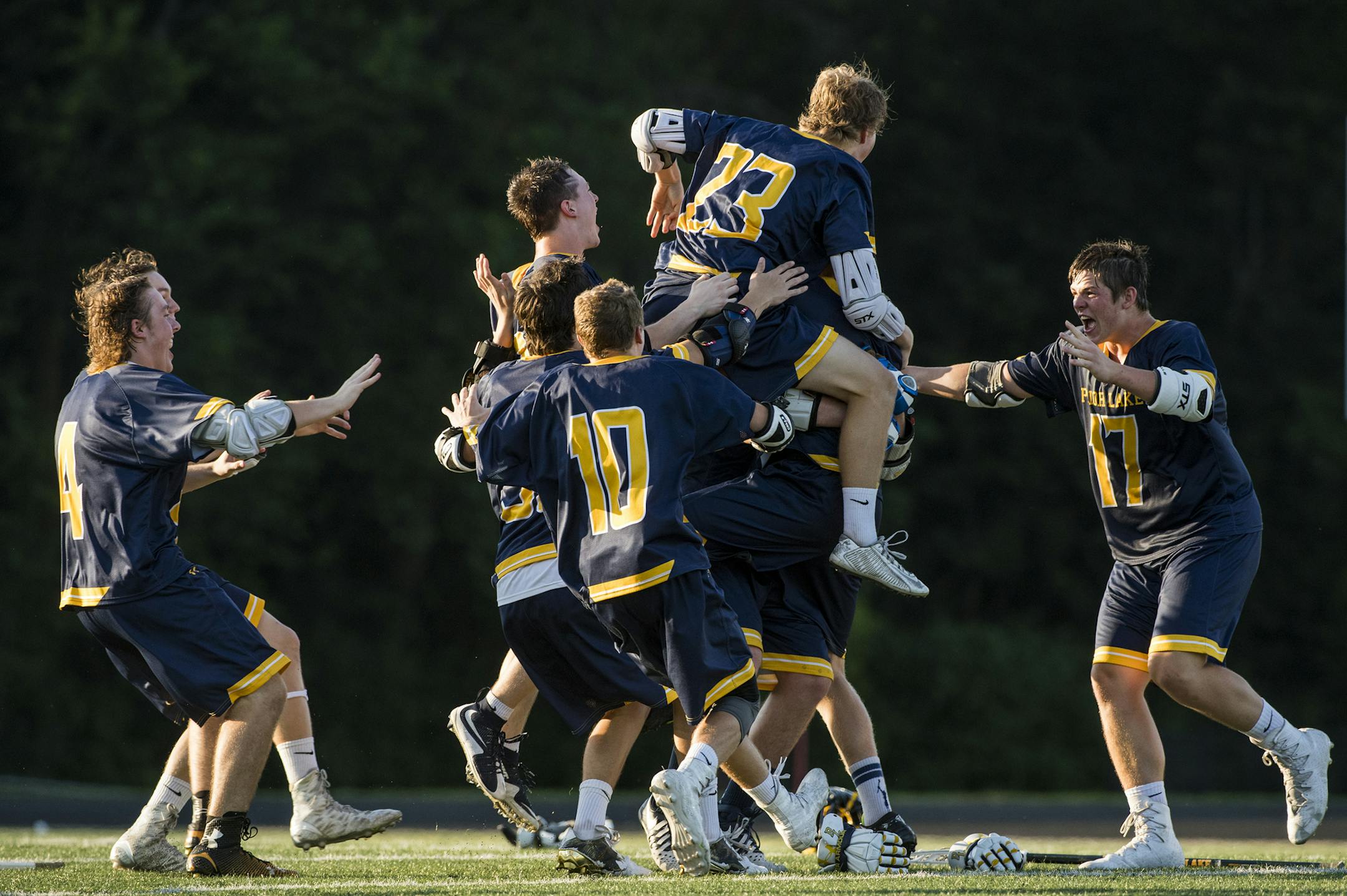 Prior Lake players celebrate with a dog pile after defeating Lakeville North 12-5. ] Isaac Hale • isaac.hale@startribune.com The Prior Lake Lakers defeated the Lakeville North Panthers 12-5 in the 2016 Minnesota State High School Boys Lacrosse Championship at Chanhassen High School on Saturday, June 18, 2016.