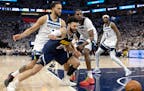 Kyle Anderson (1) and Naz Reid (11) of the Minnesota Timberwolves guard Jamal Murray (27) of the Denver Nuggets in the third quarter of Game 4 of the 
