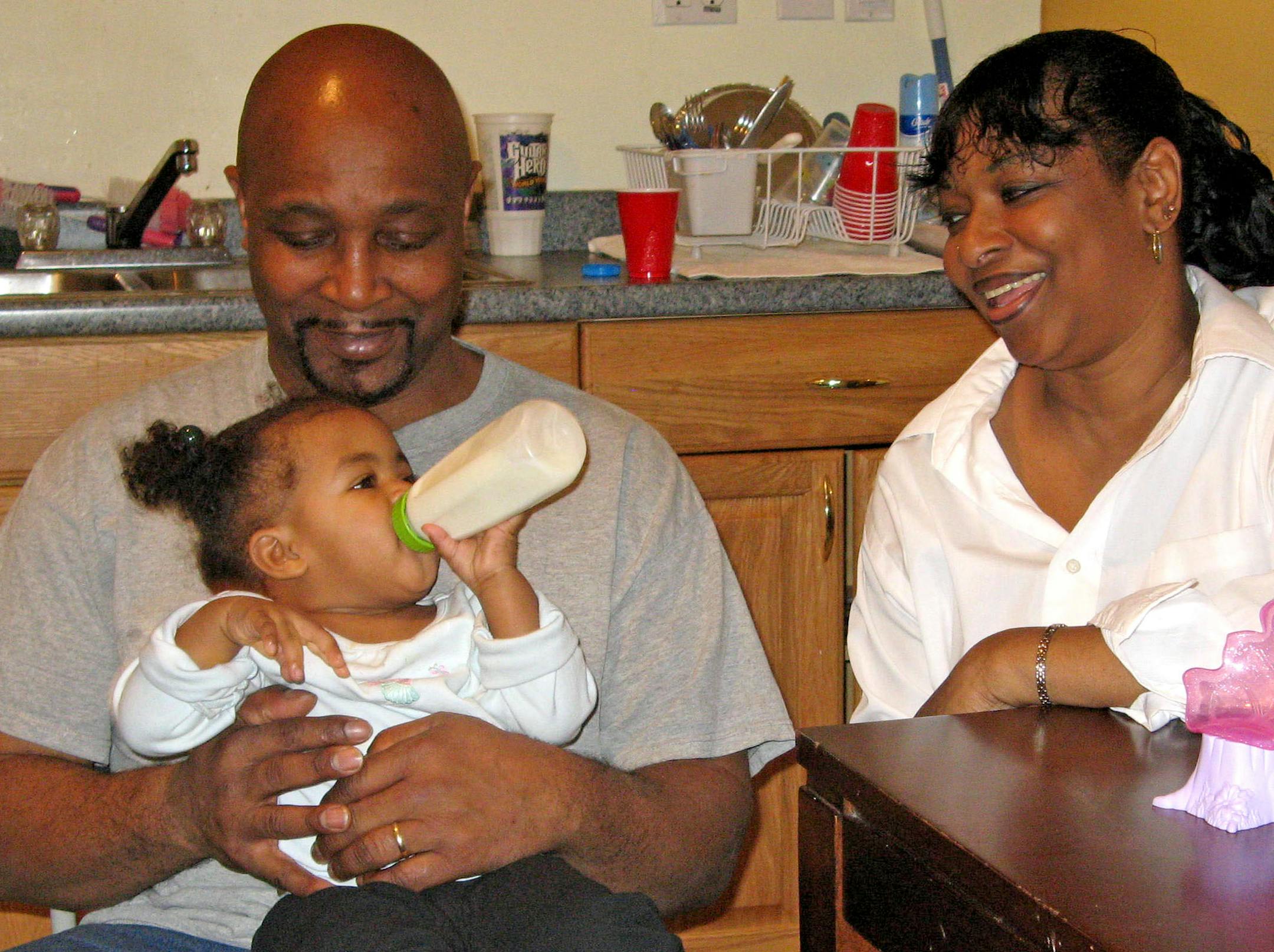 A fire that burned them out of their apartment in August and a job layoff last month didn't stop Vernon and Helena Satterfield of north Minneapolis from adopting four siblings who joined them in a new house Dec. 1. The Satterfields, who have mentored many kids in the past 20 years, said they believe this is the family they were meant to have. Above, Vernon, Angel, 1, and Helena.