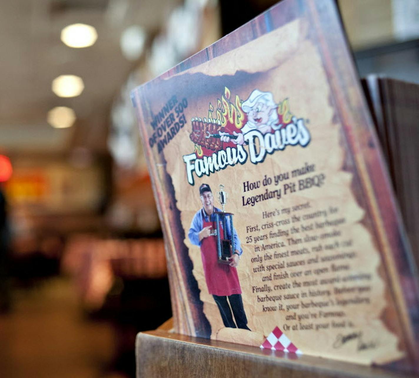 A menu sits at the hostess stand of a Famous Dave's of America Inc. franchise restaurant in Peoria, Illinois, U.S., on Thursday, March 21, 2013. Famous Dave's of America is a chain of barbecue restaurants started in 1994 that has 191 locations in 34 U.S. states and one Canadian province. Photographer: Daniel Acker/Bloomberg