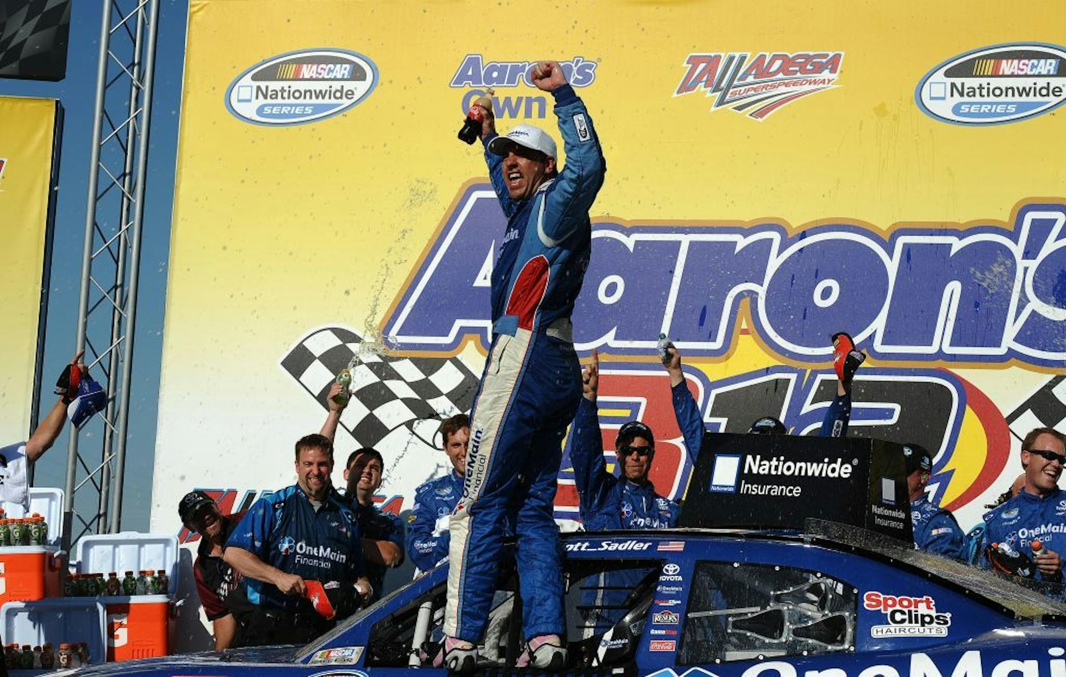Elliott Sadler celebrates winning the NASCAR Aaron's 312 Nationwide series auto race at Talladega Superspeedway, Saturday, May 3, 2014, in Talladega, Ala.