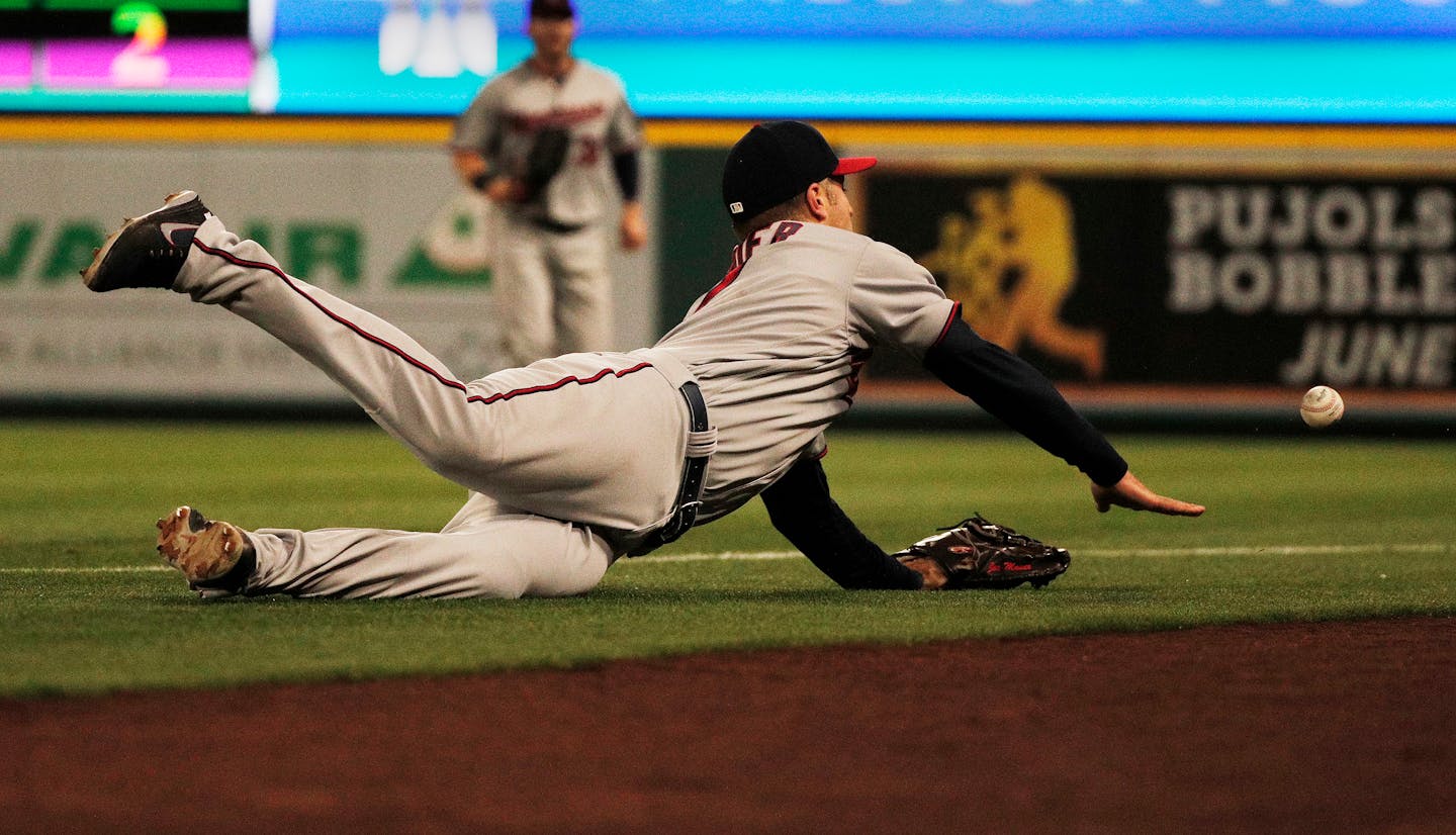 Minnesota Twins first baseman Joe Mauer dives but can't reach a foul ball hit by the Los Angeles Angels' Justin Upton in the third inning at Angel Stadium in Anaheim, Calif., on Friday, May 11, 2018.