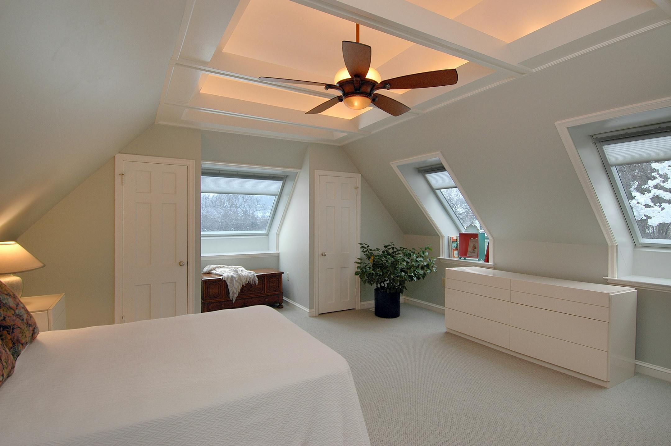 The house has three bedrooms upstairs, including this guest bedroom, as well as a main-floor bedroom suite.