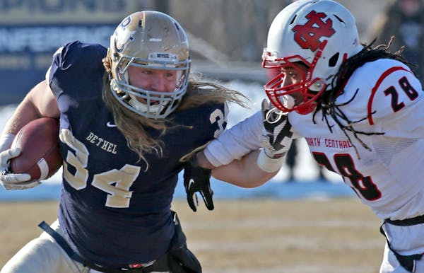 Bethel University vs. North Central, Division 3 NCAA playoff, Royal Stadium, 12/7/13. (left to right) Bethel's Jesse Phenow was chased down by North C