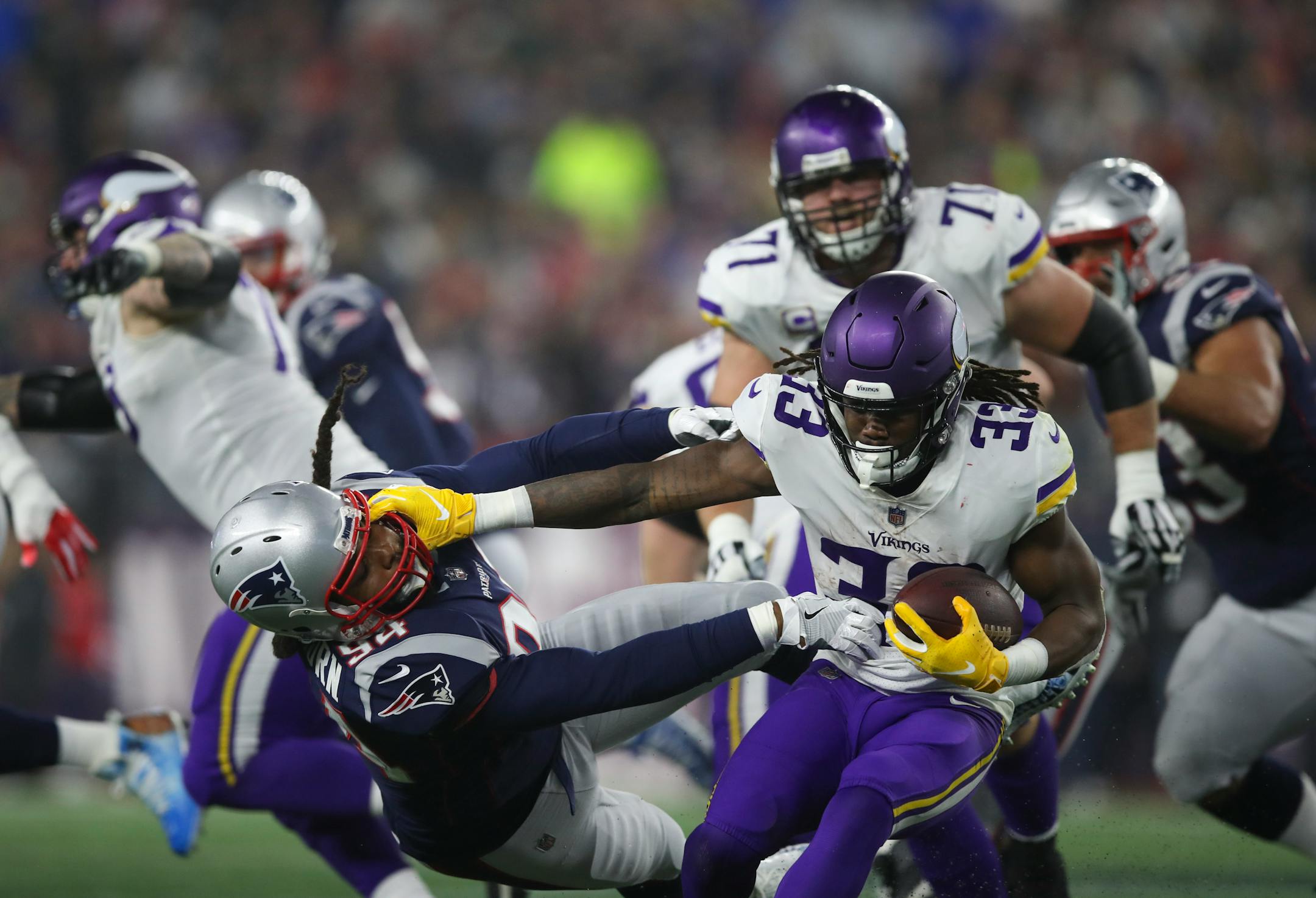 Vikings running back Dalvin Cook (33) fended off Patriots defensive end Adrian Clayborn (94) while ultimately gaining nothing on a fourth-quarter run Dec. 2.