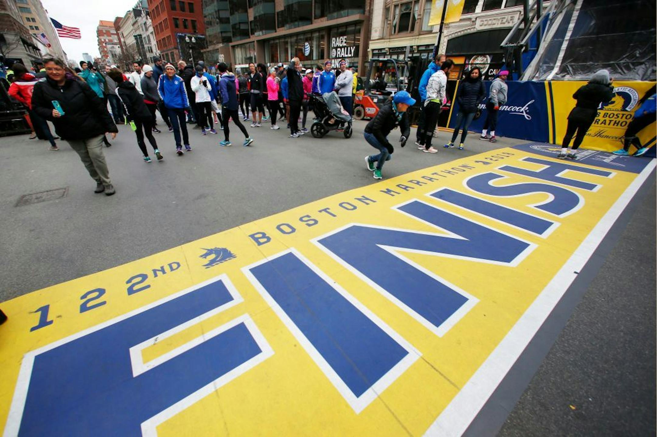 People gather at the Boston Marathon finish line ahead of the 2018 race.