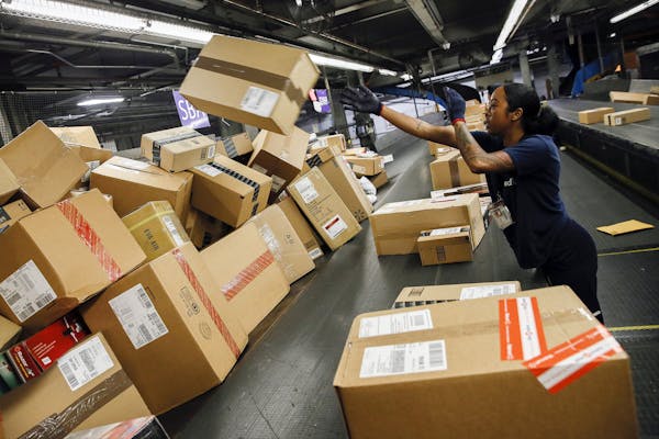An employee sorts packages inside the FedEx Corp. distribution hub at Los Angeles International Airport on Dec. 15, 2014. MUST CREDIT: Bloomberg photo