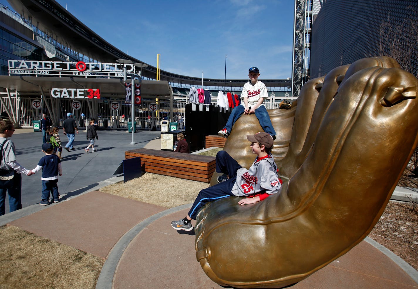 DAVID JOLES â€¢ djoles@startribune.com -April 8, 2011- Minneapolis, MN- : The Minnesota Twins home opener of 2011 against Oakland Athletcis. In this photo:] photo:] Jonathan Gamble, 12, front, and Bryan Cydow, 12, both of Inver Grove Heights, take in the pregame festivities from the mitt on the Plaza outside Target Field. ORG XMIT: MERc3fc128c8445aaf94c525b0040e83