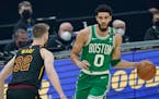Boston’s Jayson Tatum drove against Cleveland’s Dean Wade on Wednesday.