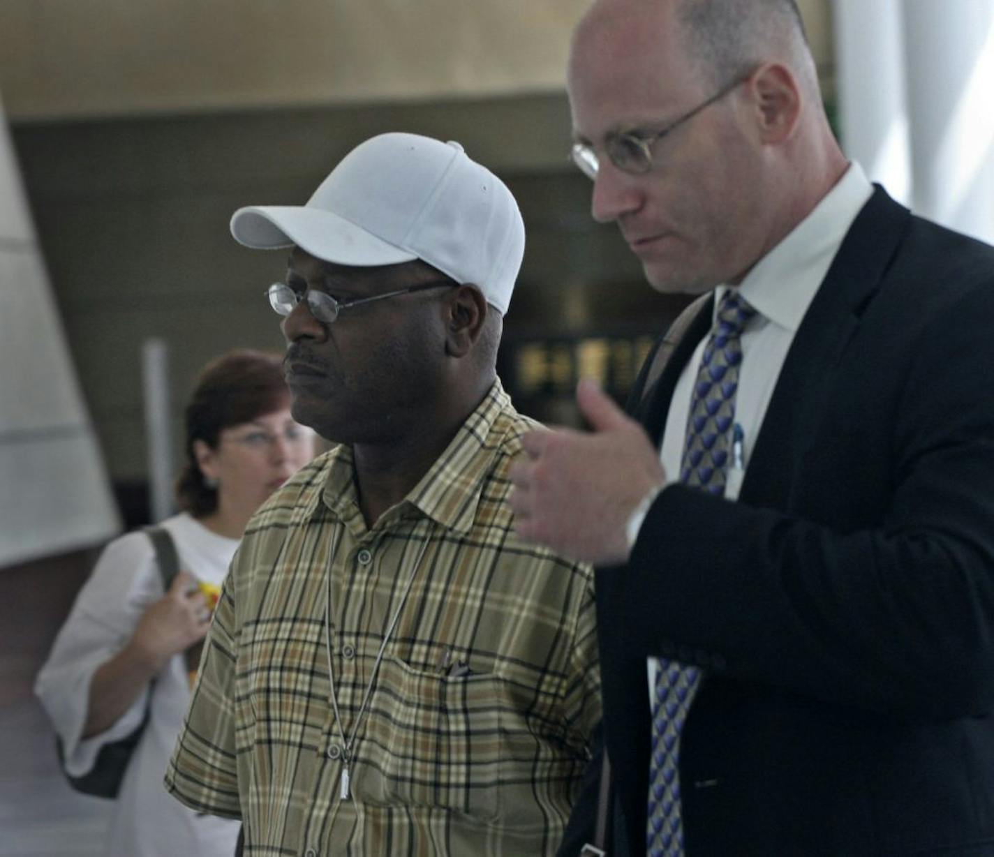 TOM SWEENEY � tsweeney@startribune.com Minneapolis, MN 6/20/2006 Former St Paul police officer Clemmie Tucker ( center/white hat) leaves US Federal court with his attorney Anthony Spector