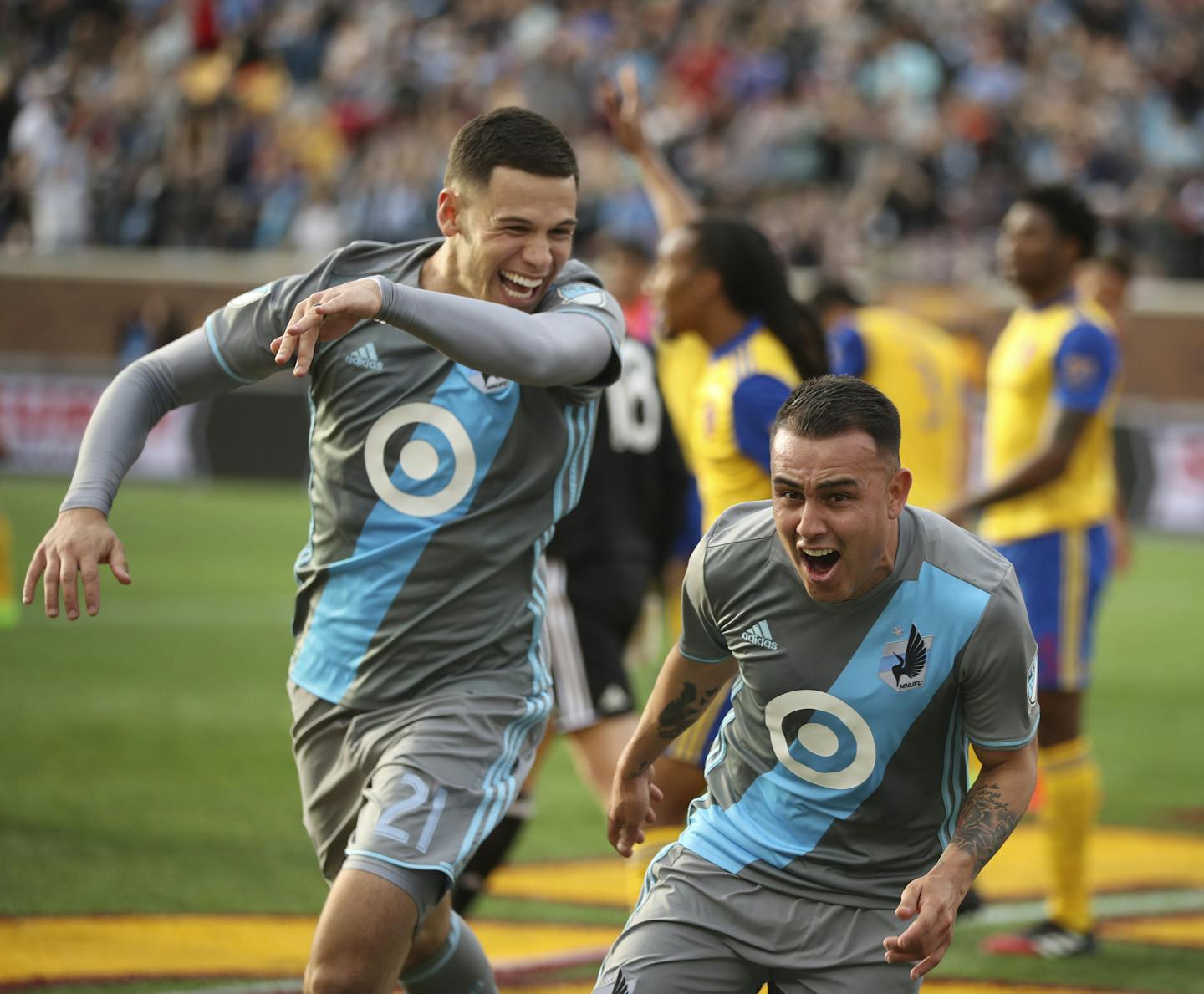 Minnesota United forward Christian Ramirez (21) helped Minnesota United midfielder Miguel Ibarra (10) celebrate a goal