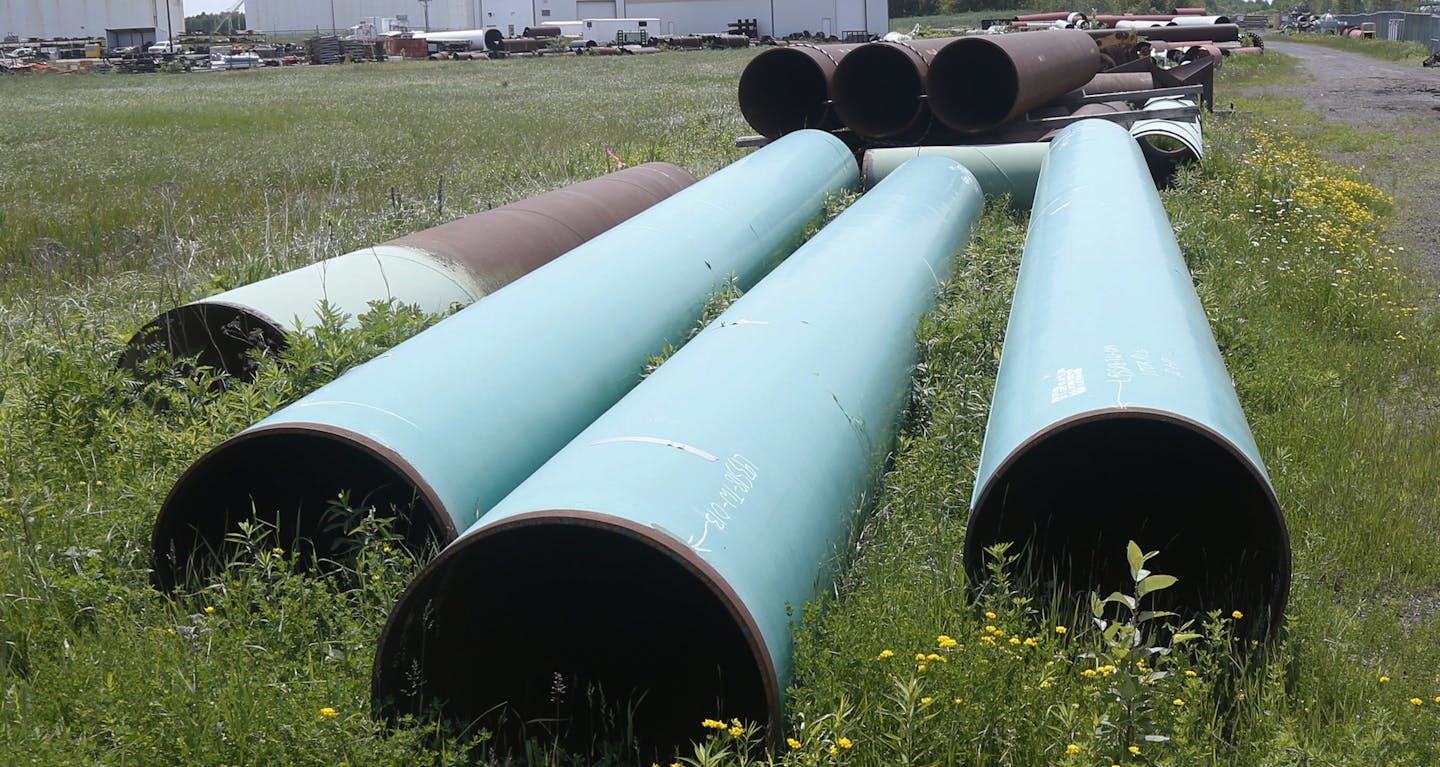 FILE - In this June 29, 2018 file photo, pipeline used to carry crude oil is shown at the Superior terminal of Enbridge Energy in Superior, Wis. An updated environmental review released by a state agency Monday, Dec. 9, 2019, found no serious threat to Lake Superior if crude oil ever leaked from a new pipeline to replace Enbridge Energy's aging Line 3 across northern Minnesota. (AP Photo/Jim Mone, File) ORG XMIT: MER4aa9ce0b44501a0d85c225ef4670f