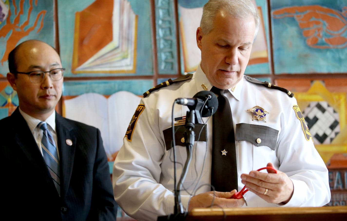 Ramsey County Sheriff Matt Bostrom looks at a gun lock while joining forces with Ramsey County Attorney John Choi to announce that Ramsey County will make available 2,500 free gun locks to encourcage gun owners to lock, secure guns to keep children and the community safe at a press conference Thursday, June 9, 2016, at the Rondo Community Outreach Library in St. Paul, MN.](DAVID JOLES/STARTRIBUNE)djoles@startribune In an urthodox effort to combat gunplay by children, the Ramsey County attorney&#